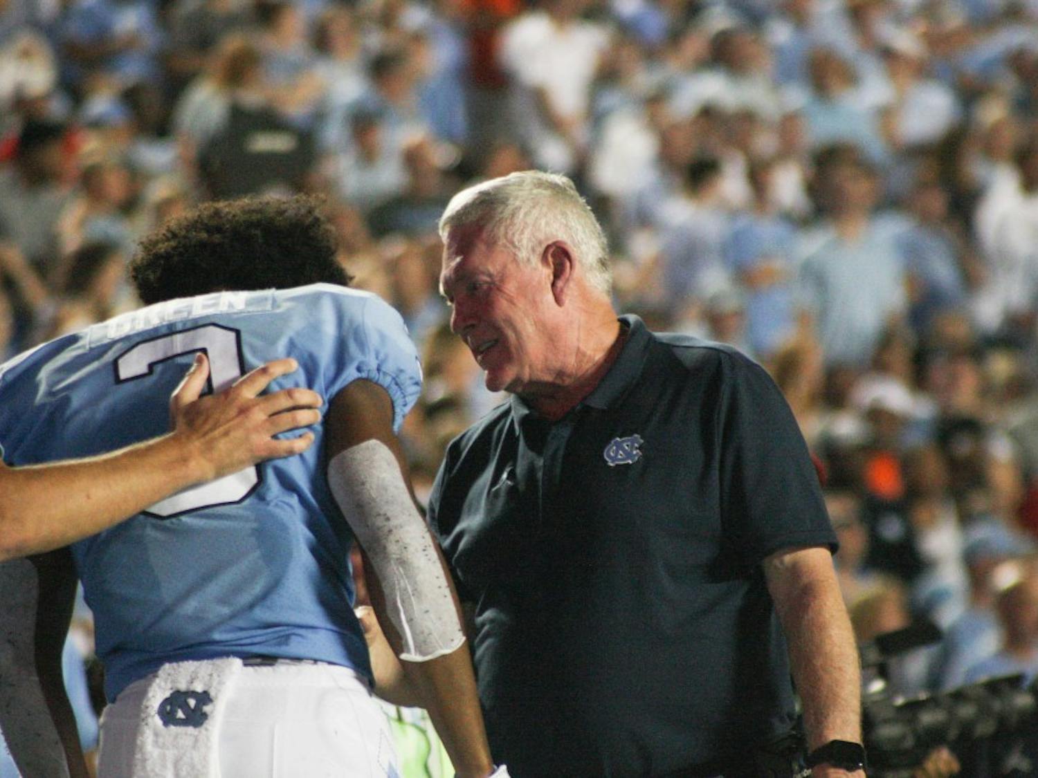 UNC football coach Mack Brown talks to wide receiver Antoine Green(3) on Saturday, Sept. 7, 2019. UNC beat Miami 28-25.