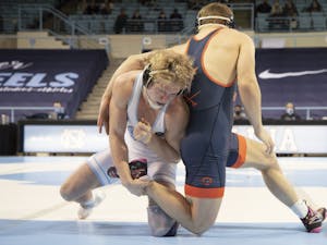 Clay Lautt wrestles against UVA's Vic Marcelli in the 174 lbs weight division in Carmichael Arena on Feb. 13, 2021. Lautt won his match and UNC won overall, 25-9.