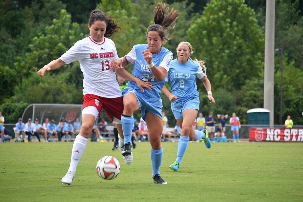 UNC's Paige Nielson (24) and NC State's Franziska Jaser (13) battle for the ball at Sunday's soccer game in Raleigh, North Carolina.  The Lady Tar Heel's won 2-1 against the Lady Wolfpack.