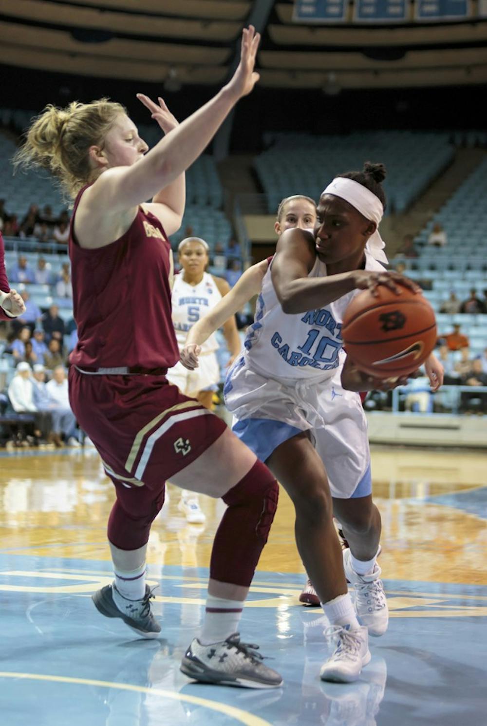 North Carolina guard&nbsp;Jamie Cherry (10) looks to pass the ball around a Boston College defender Thursday night.