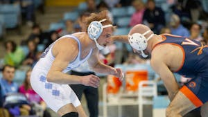 Graduate student Zach Sherman faces off against his opponent during a wrestling match against UVA on Friday, Jan. 27, 2023, in Carmichael Arena. UNC won 30-9.