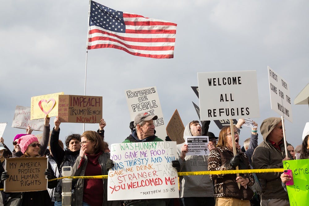 <p>Protesters gather outside terminal two at RDU Airport on Jan. 29 in response to President Donald Trump's executive order banning immigrants from certain countries from entering the U.S.</p>