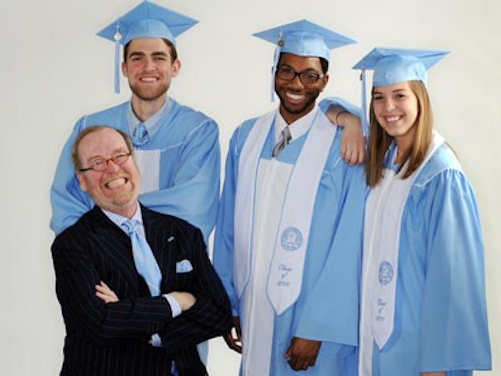	Alexander Julian, bottom left, designed the new graduation gowns worn here by son Will, senior class vice president Justin Tyler and senior class chief marshal Chelsea Phillips. Photo courtesy of UNC.