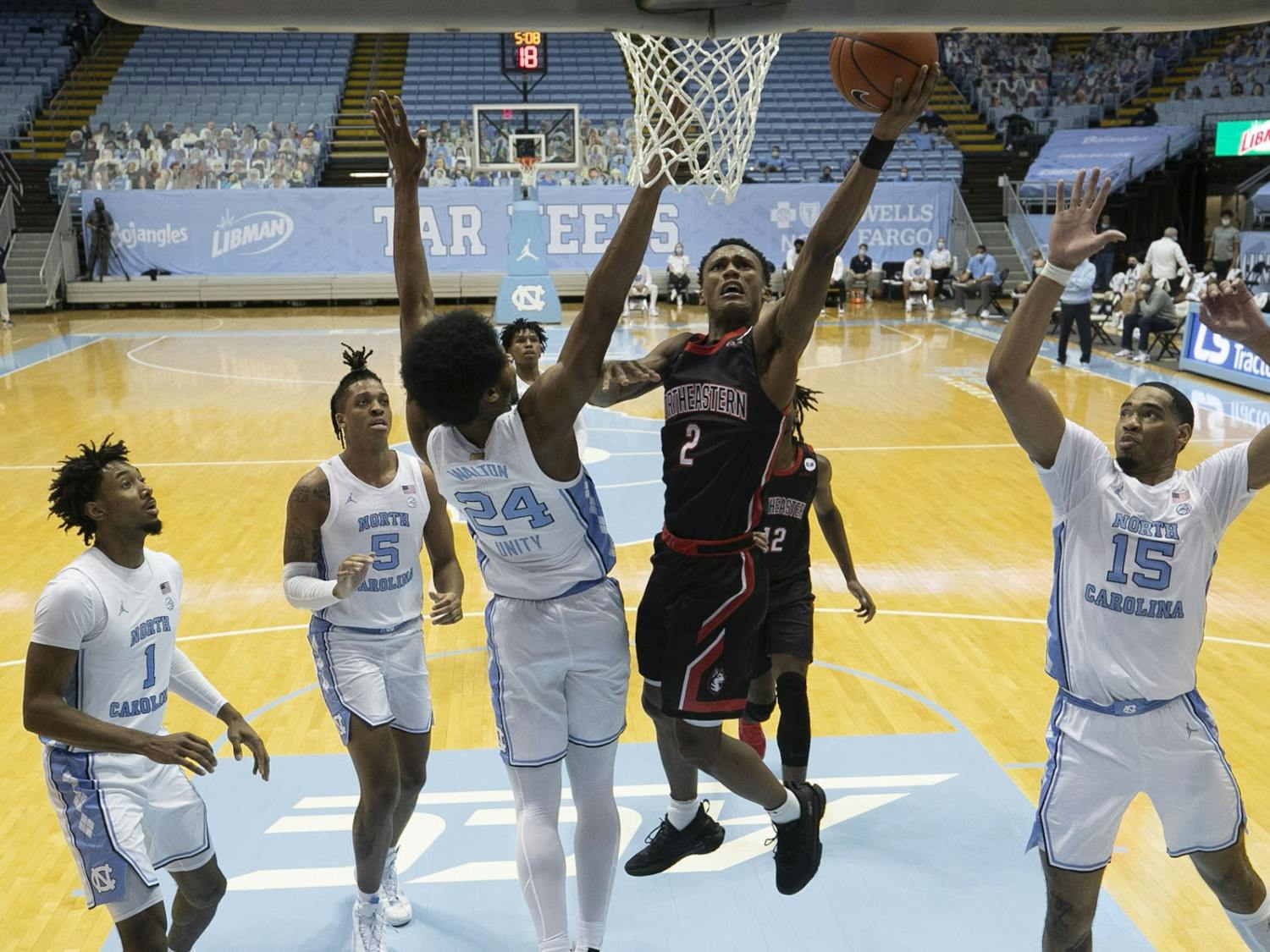 Northeastern’s Tyson Walker (2) drives to the basket for two of his game high 27 points during the second half against North Carolina on Wednesday, February 17, 2021 at the Smith Center in Chapel Hill, N.C. Photo courtesy of Robert Willett.