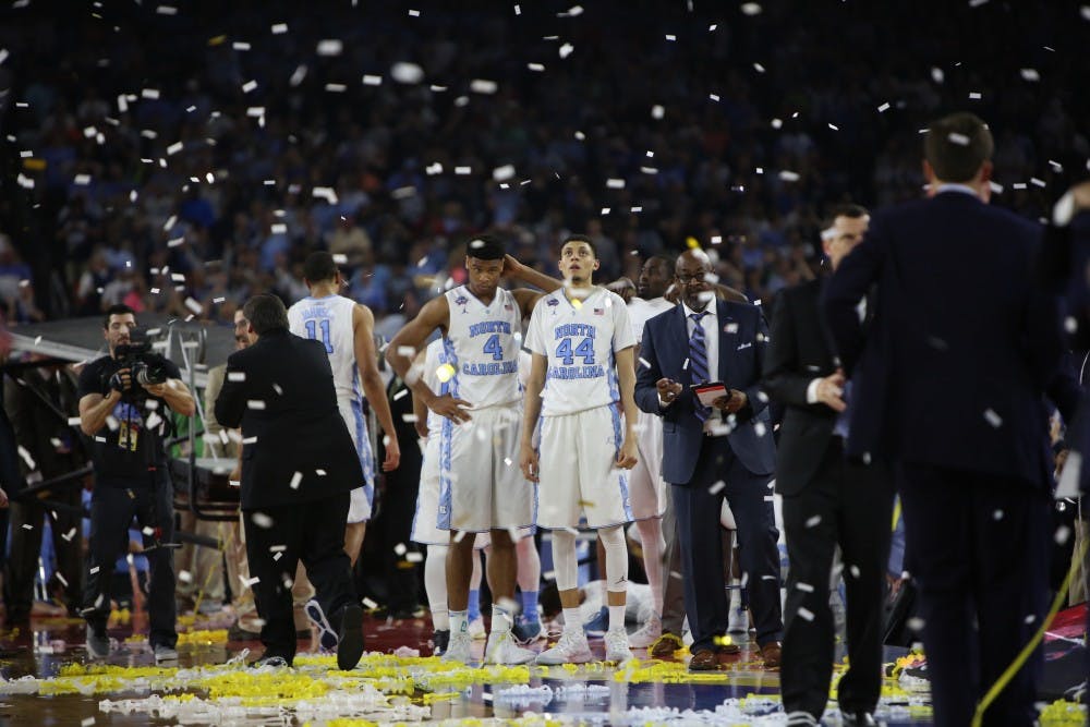 Justin Jackson (44) looks at the scoreboard as confetti falls after the national championship in 2016. The Tar Heels hope to take the title this year following the 77-74 loss to Villanova last year.&nbsp;