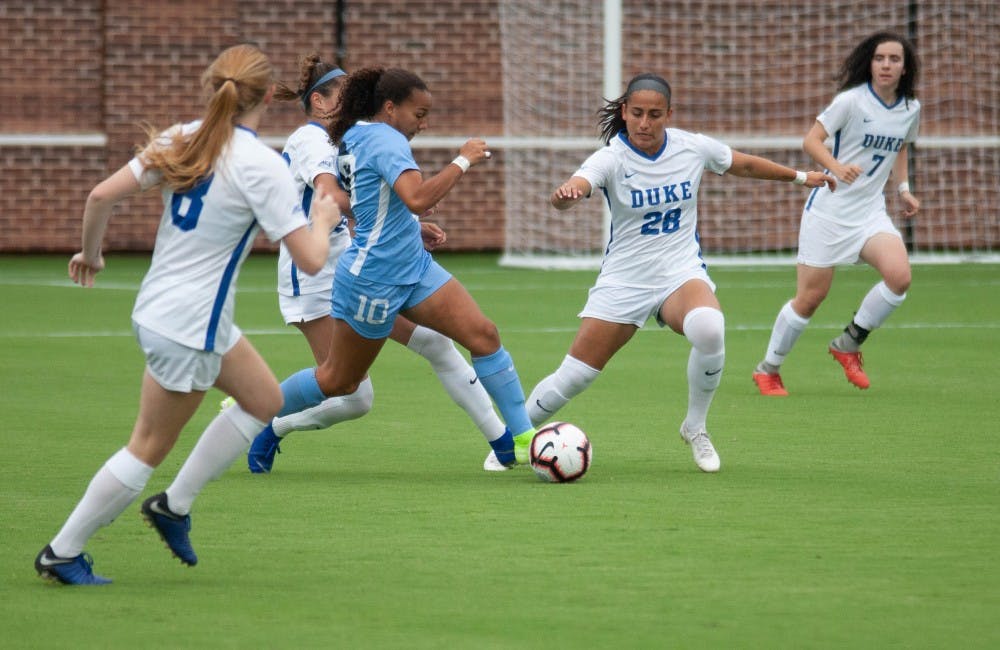 UNC women's soccer forward, Rachel Jones (10) dribbles past defenders during a game against Duke on Sunday August 25, 2019. UNC beat Duke 2-0.