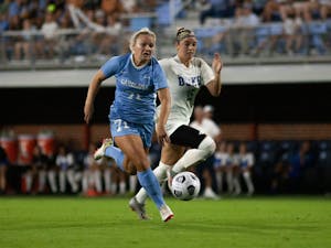 UNC sophomore forward Mollie Baker (71) runs with the ball at the game against Duke at Dorrance Field on Sept. 17. UNC lost 1-0.