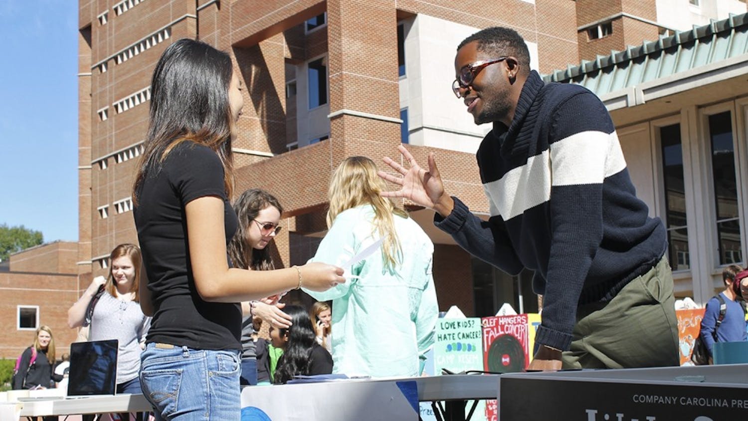 Roderick Gladney (right), founder and chairman of Carolina Cupboard, an organization that provides free food to the UNC campus community, helps recruit new members in the Pit in October 2014. DTH file photo by Johanna Ferebee.