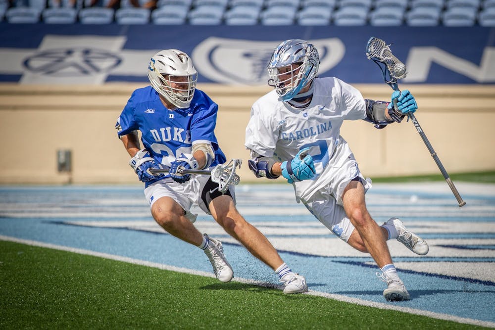 UNC junior attackman Jacob Kelly (9) sprints to the goal during the Tar Heels' 15-12 victory against Duke on Sunday, May 2. With the victory, UNC and Duke share the 2021 ACC regular season title.