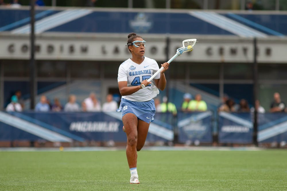 Freshman defender Brooklyn Walker-Welch (45) cradles the ball up the field during UNC's NCAA Tournament semifinal match against Northwestern at Homewood Field in Baltimore, M.D. on May 27, 2022. UNC won 15-14.
