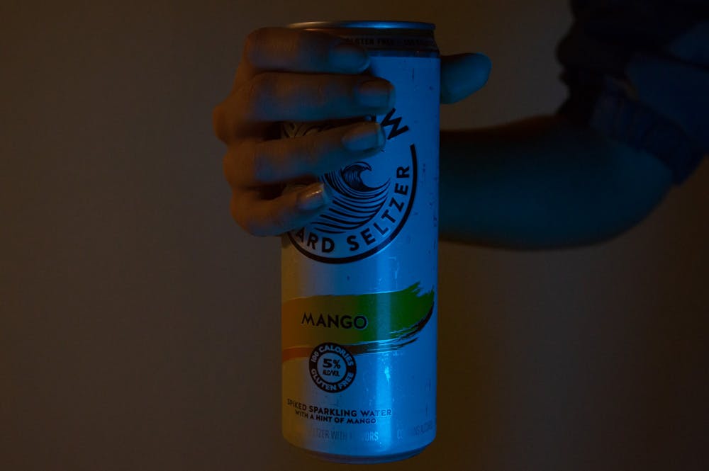 DTH Photo Illustration. Someone holds a can of hard seltzer which contains 5% alcohol.