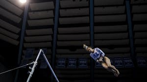 Sophomore Isabelle Schaffer competes on uneven bars during Carolina Gymnastics' home tri-meet on Monday, Jan. 23, 2023.