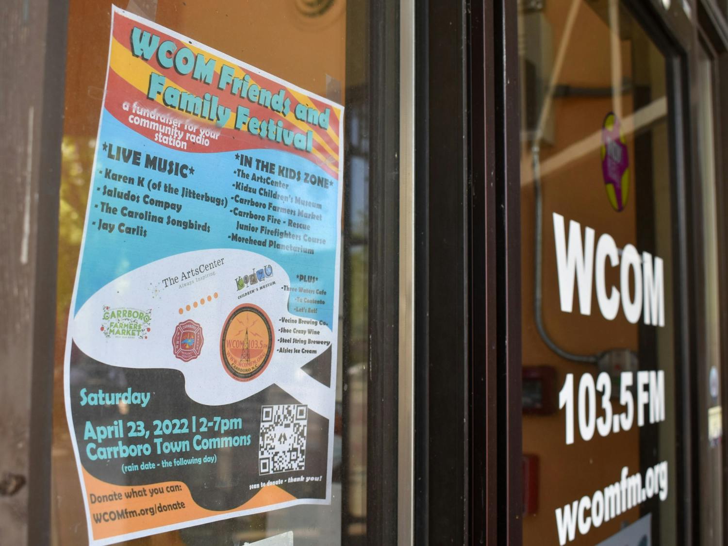 A sign outside the WCOM studio in Carrboro advertises the "WCOM Friends and Family Festival."
