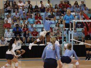 Destiny Cox, freshman and outside hitter for UNC's women's volleyball team, strikes the ball in a game against N.C. State on Wednesday, Sept. 29, 2018.