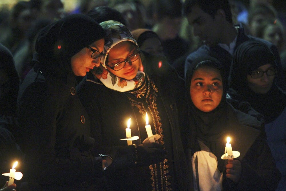 <p>Mourners hold candles at a vigil in the Pit for Deah Shaddy Barakat, Yusor Mohammad Abu-Salha and Razan Mohammad Abu-Salha on Wednesday.</p>