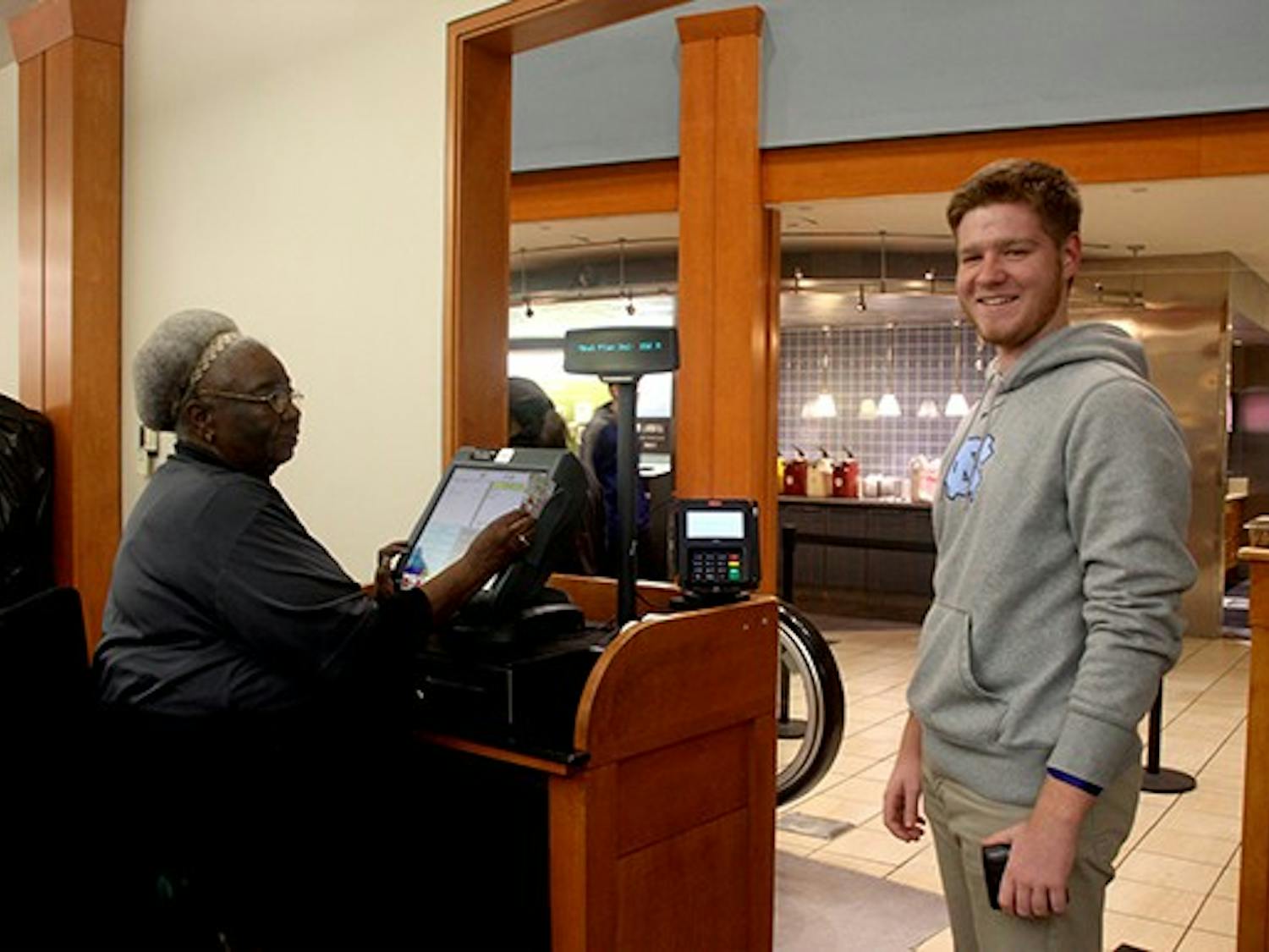 Matthew Watts, a Junior major in economics and geography, is using the new CDS plus swipe system in Lenoir dinning hall. 
