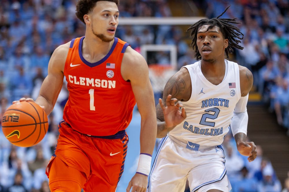 <p>UNC junior guard Caleb Love (2) watches Clemson junior guard Chase Hunter (1) as he runs down the court during the men's basketball game against Clemson at the Dean E. Smith Center on Saturday, Feb. 11, 2023. UNC beat Clemson 91-71.</p>