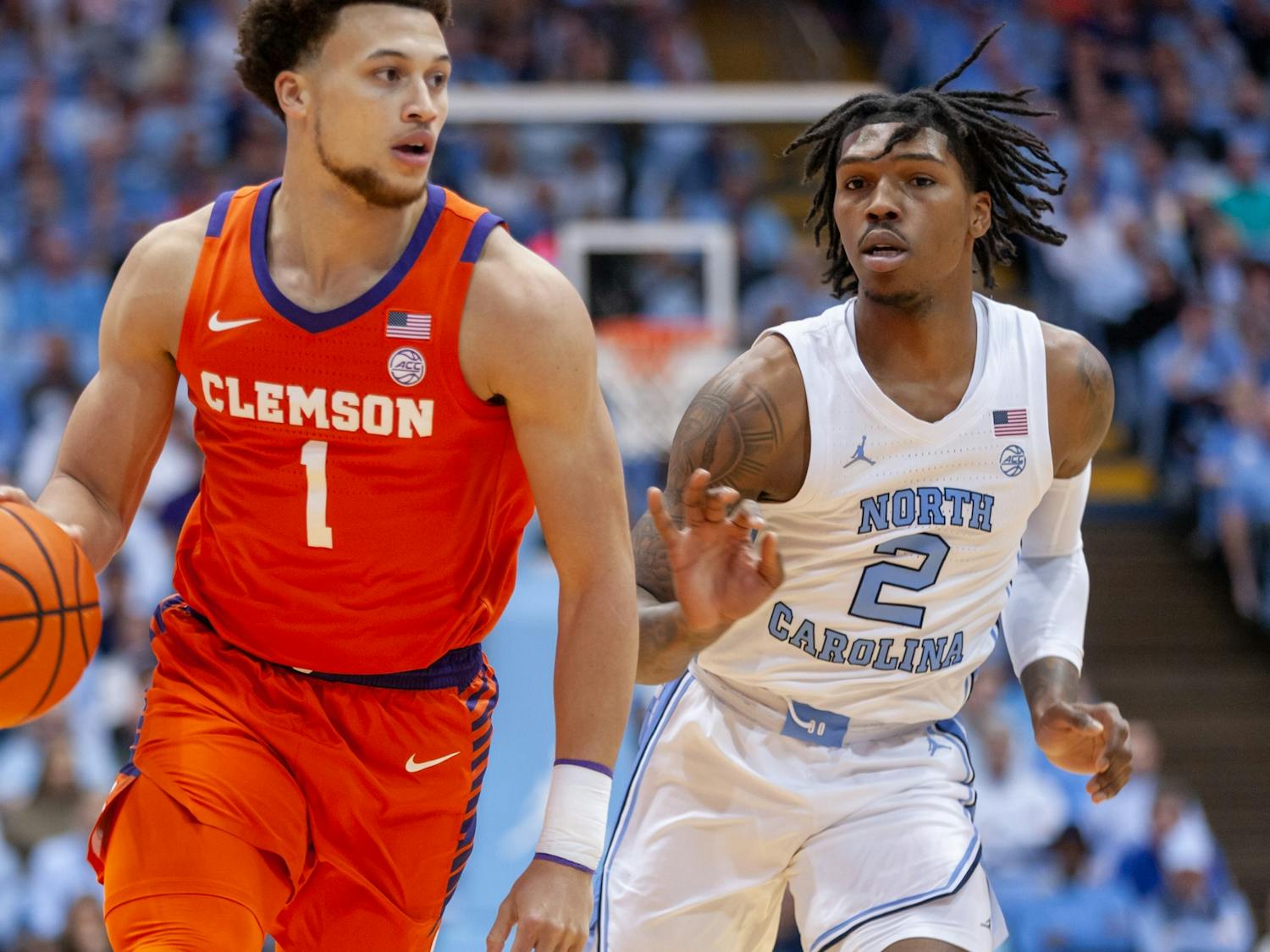 UNC junior guard Caleb Love (2) watches Clemson junior guard Chase Hunter (1) as he runs down the court during the men's basketball game against Clemson at the Dean E. Smith Center on Saturday, Feb. 11, 2023. UNC beat Clemson 91-71.