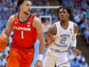 UNC junior guard Caleb Love (2) watches Clemson junior guard Chase Hunter (1) as he runs down the court during the men's basketball game against Clemson at the Dean E. Smith Center on Saturday, Feb. 11, 2023. UNC beat Clemson 91-71.
