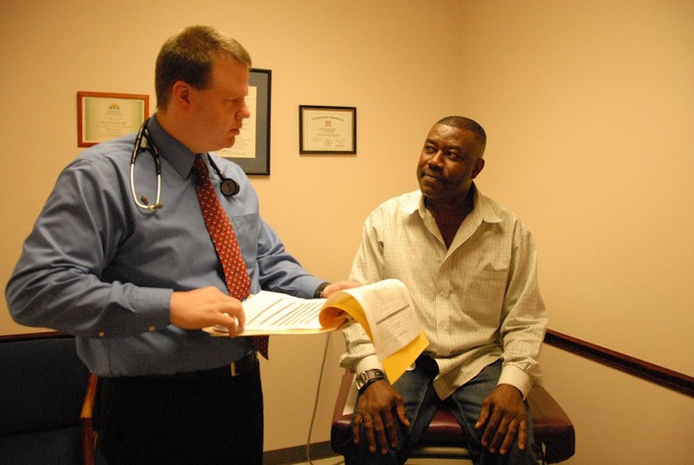 Dr. Brian Forrest informs his patient Franklin Torere of his results after a physical. DTH/Helen Woolard