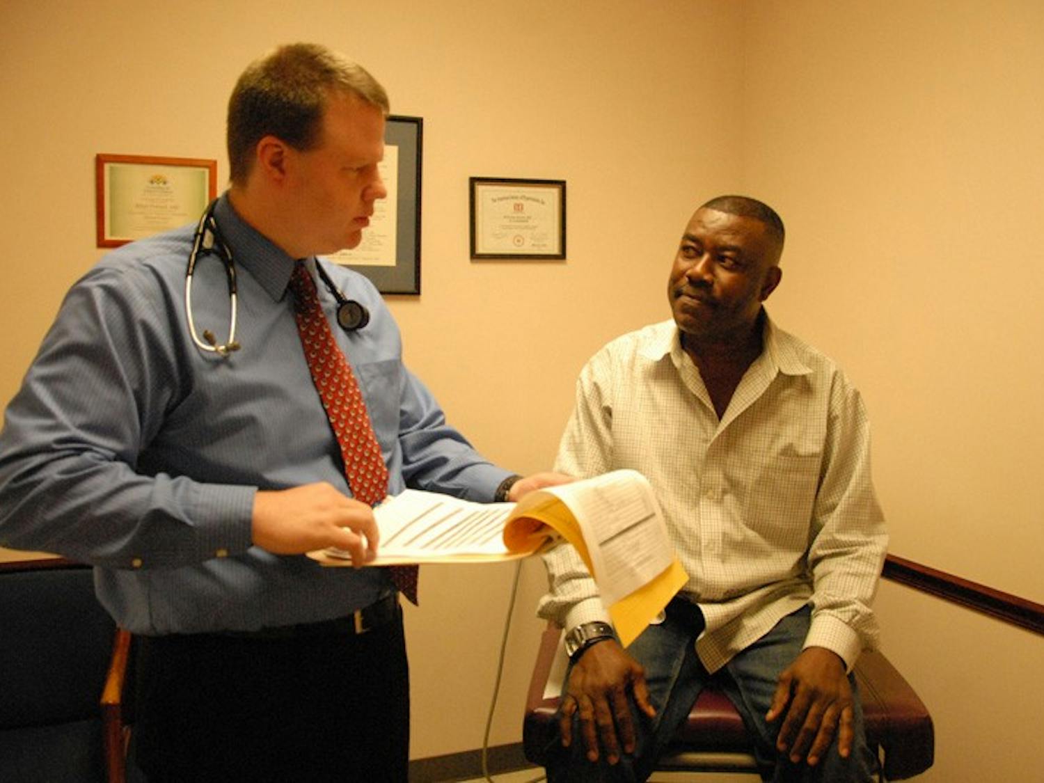 Dr. Brian Forrest informs his patient Franklin Torere of his results after a physical. DTH/Helen Woolard