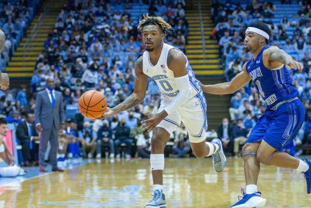 <p>Redshirt-sophomore guard Anthony Harris (0) passes the ball to a teammate at the exhibition game against Elizabeth City State on Nov. 5, 2021, at the Dean Smith Center. UNC won 83-55.</p>