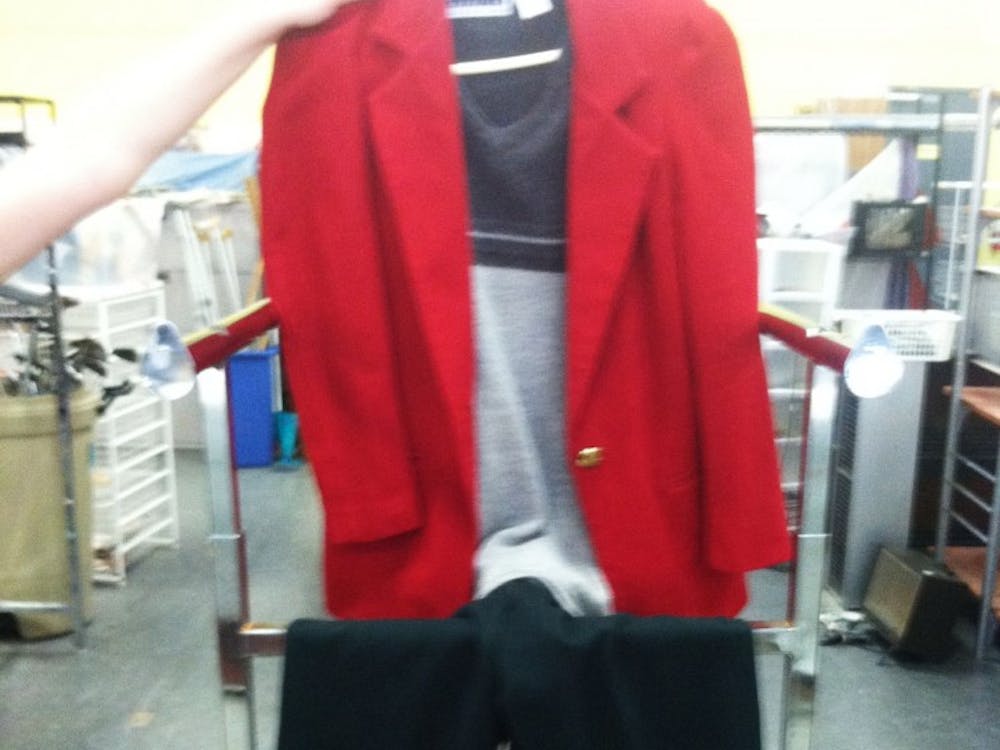 	An outfit made up of three PTA items: a gray sweater vest, a red blazer with gold buttons and a pair of green pants.