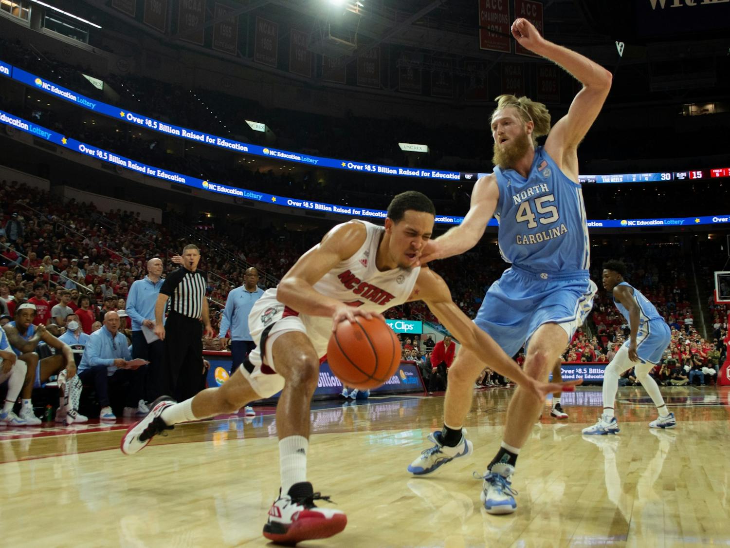 Graduate forward Brady Manek (45) defends against NC State's Jericole Hellems (4) in the first half of the game against NC State game at the PNC Arena in Raleigh, NC on Feb. 26, 2022.