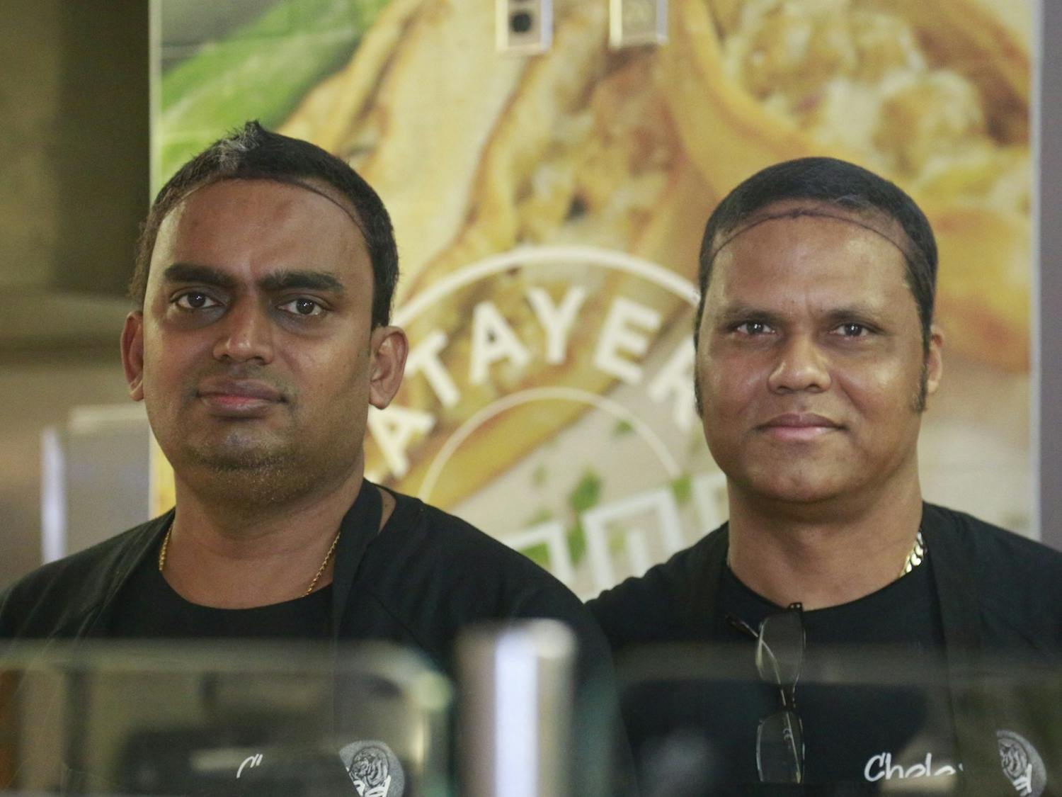 Raja Subramanian and Durai Murugan Somasundaram pose for a portrait at CholaNad in the bottom of Lenoir on Wednesday, Feb. 5, 2020. They are from Tamil Nadu, a southern region in India that inspires many CholaNad dishes.