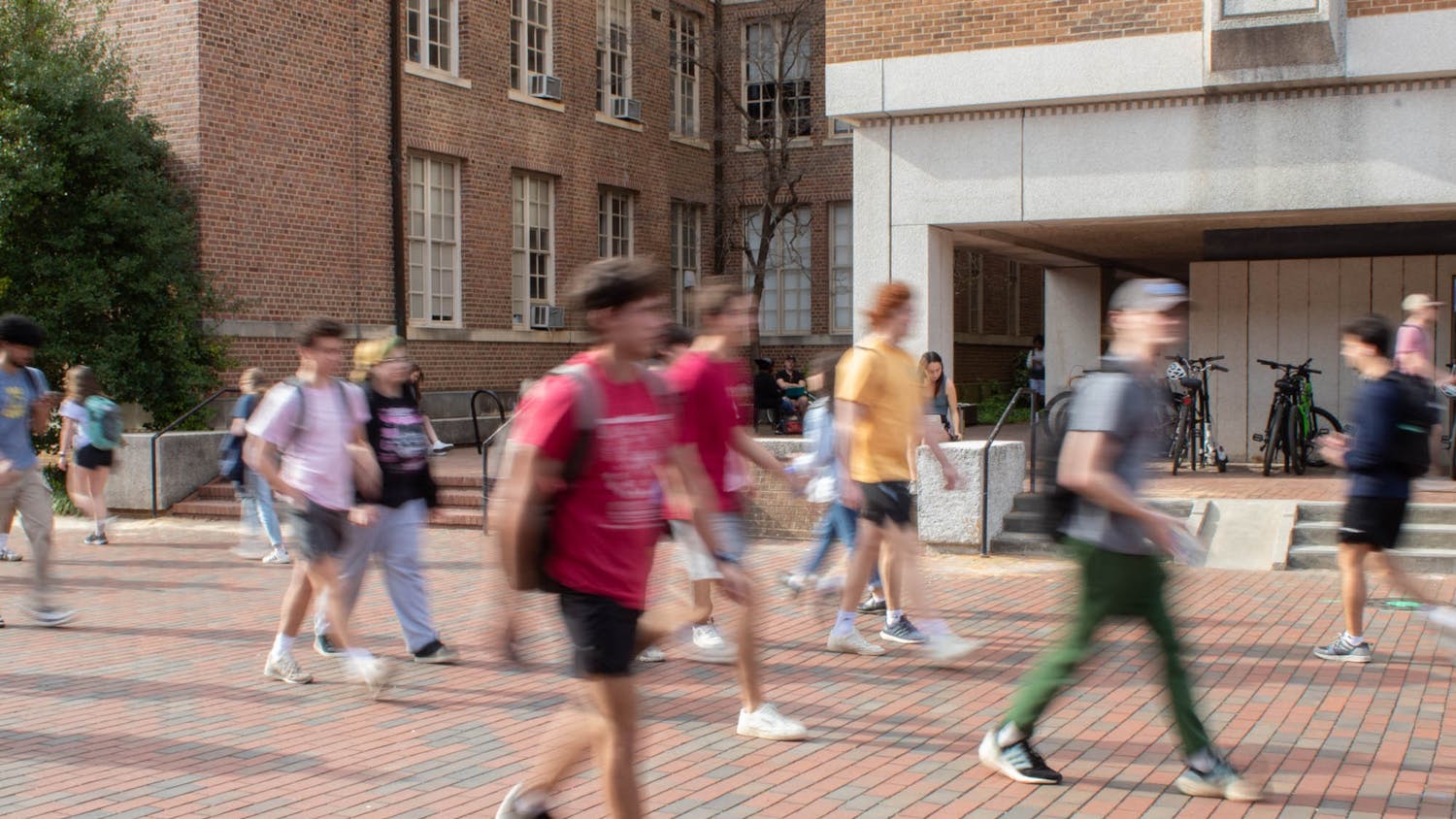 A blur of students traverse the UNC grounds on Monday, March 6, 2022.