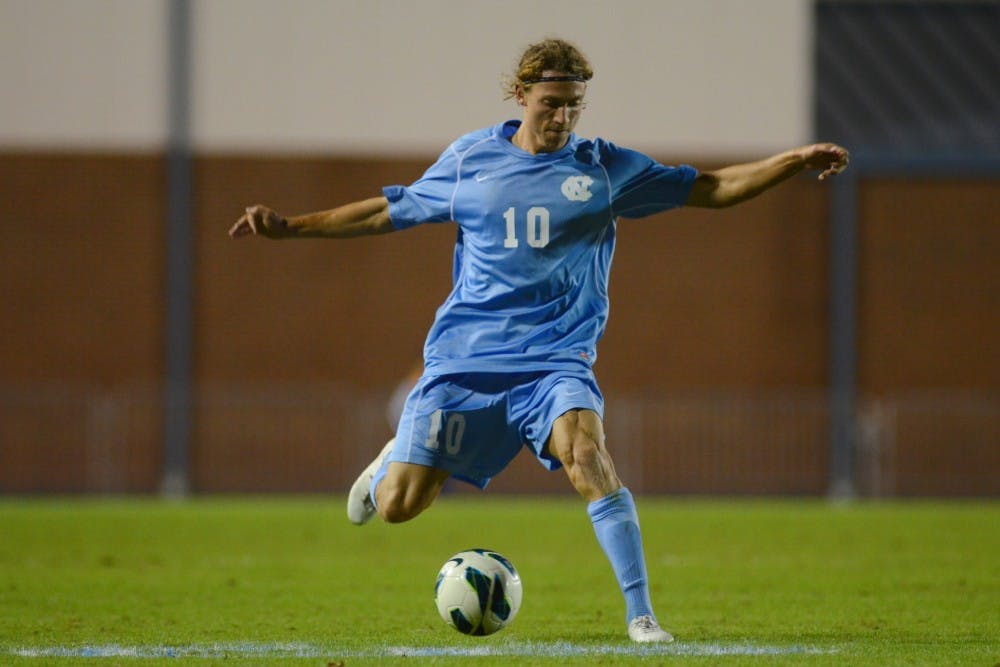 UNC Junior Andy Craven (10) crosses the ball. 