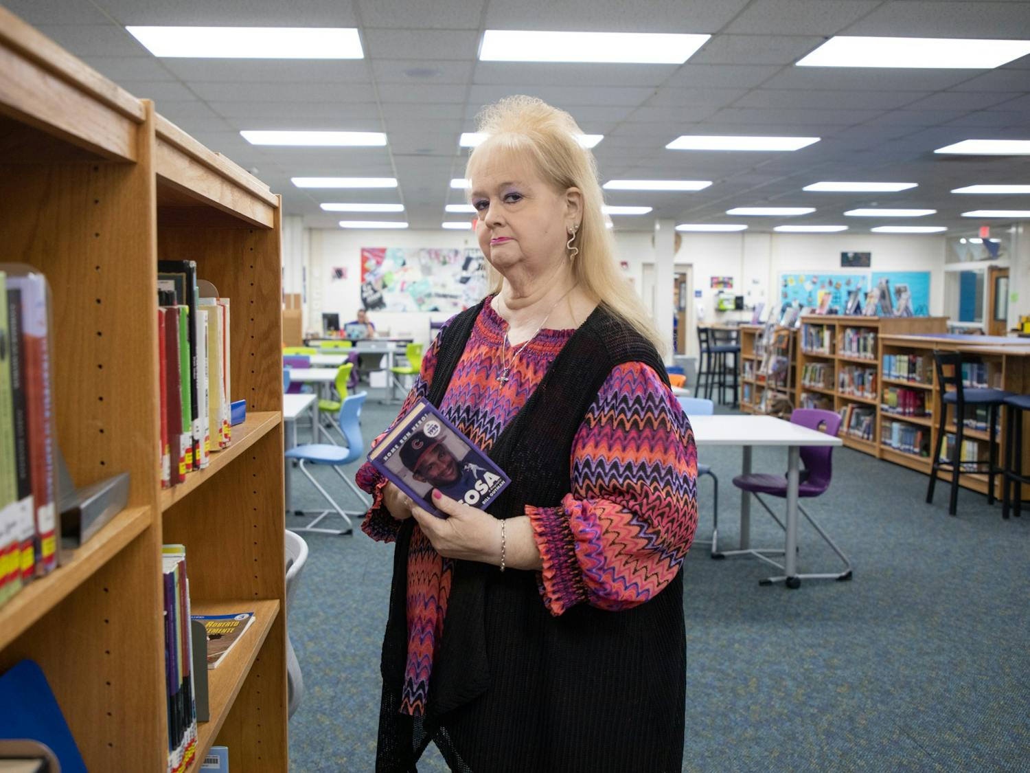 Kaye Martinez, librarian at Culbreth Middle School, poses for a picture in Culbreth's library on Sept. 2, 2022. This year will be Martinez's 36th at the school.