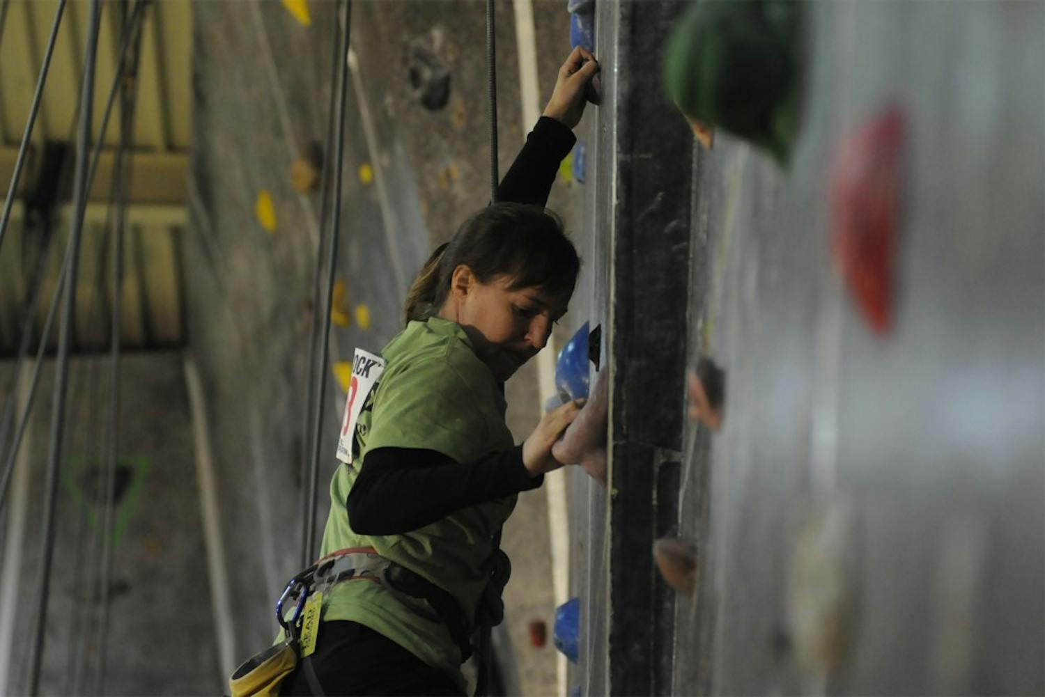 This weekend the Chapel Hill Community Center held the 25th Anniversary Dixie Rock Climbing Competition.  Kat Richards, a regular at the community center and a Chapel Hill native, is seen climbing one of the 17 wall routes.  Individuals received points for each route they completed.