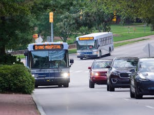 Two Chapel Hill Transit buses, the D bus and NS bus, drive up South Columbia Street on Wednesday, Sept. 2, 2020.