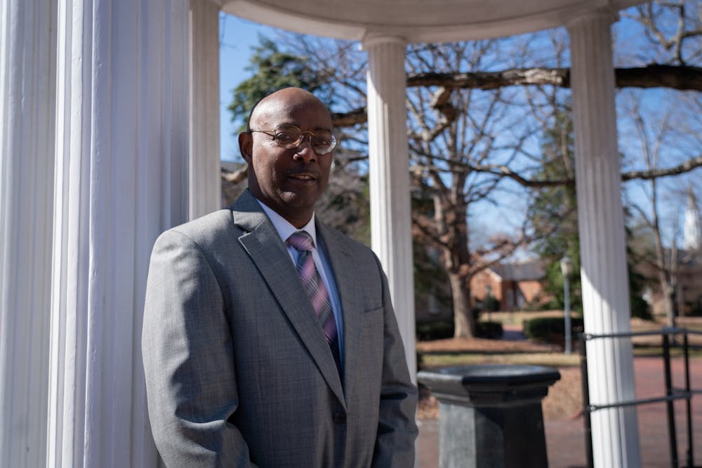 Robert Smith III stands next to the Old Well on Monday, Feb. 14, 2022. Smith was recently named vice dean of UNC Gillings School of Global Public Health and will begin on Feb. 28.