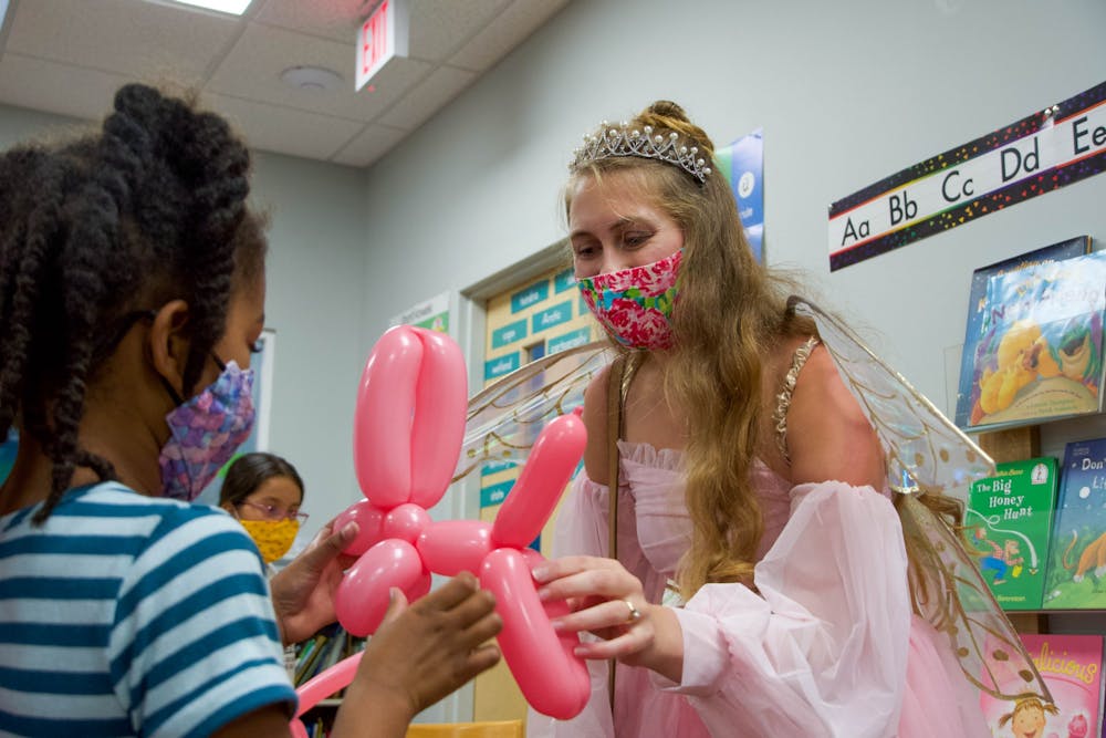 <p>Caroline Jennings, a third-year dental student, dresses as the tooth fairy and makes balloon animals as she volunteers on Wednesday, Oct. 6, 2021, for DEAH day.</p>