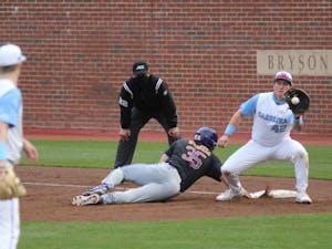 UNC sophomore left-handed pitcher Will Sandy (41) attempts to pick off ECU outfielder Bryson Worrell at first base during the Tar Heels' game against East Carolina University at Boshamer Stadium on March 23, 2021. The Tar Heels defeated the Pirates 8-1.
