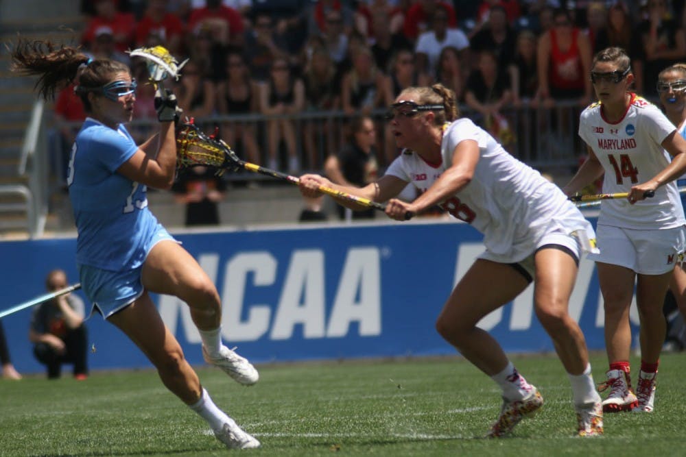 UNC midfielder Sammy Jo Tracy (13) pulls the ball back from a Maryland defender.&nbsp;The North Carolina women's lacrosse team defeated Maryland 13-7 to capture the NCAA championship on Sunday at Talen Energy Stadium in Chester, PA.