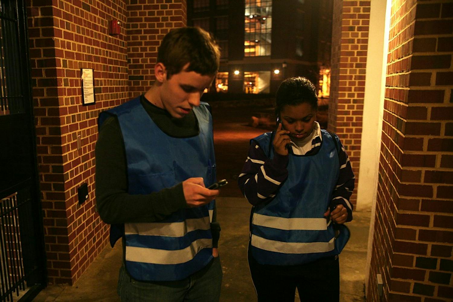 McKinney Brown, left, and Ariel Eure call the SafeWalk dispatcher on January 19, 2010.