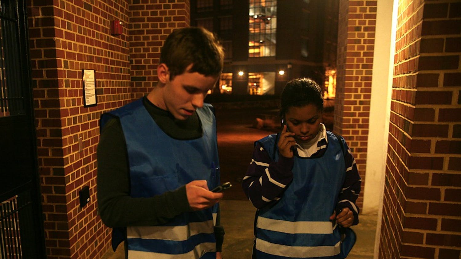McKinney Brown, left, and Ariel Eure call the SafeWalk dispatcher on January 19, 2010.