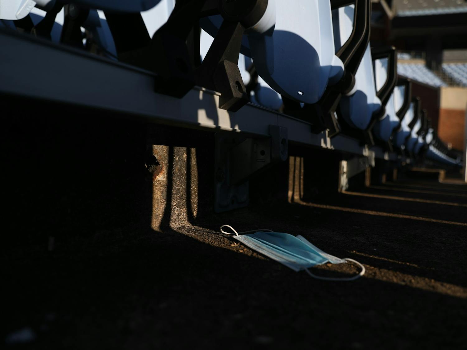 A discarded mask lies under empty chairs in Kenan Stadium on Thursday, Jan. 6, 2022.