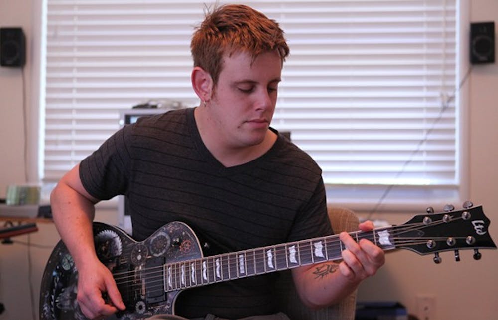 James Carlson practices on his newest guitar. DTH/Stephen Mitchell