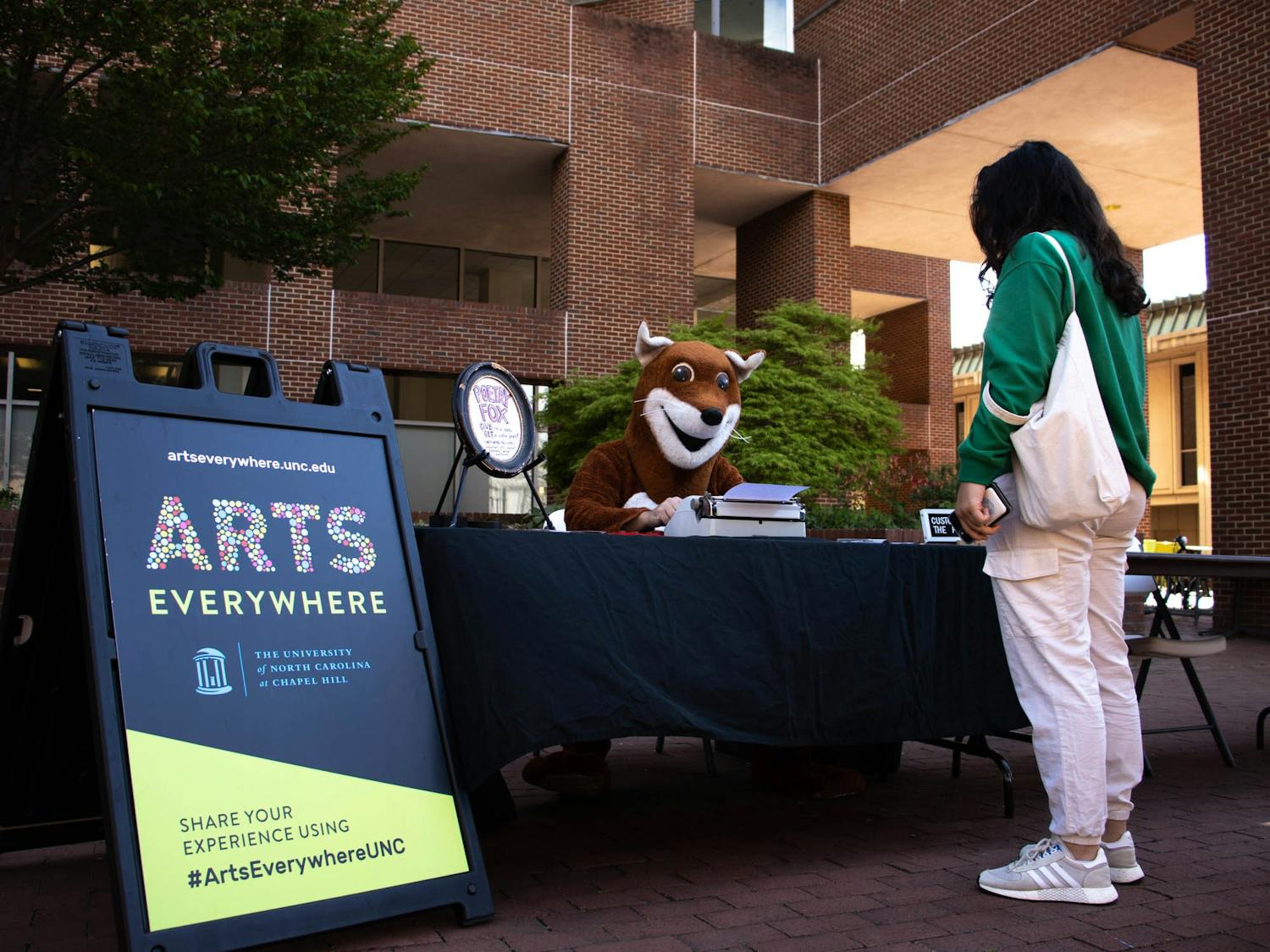 The Poetry Fox creates custom poetry for a student for Arts Everywhere day in front of Davis Library  on Friday, April 8, 2022.