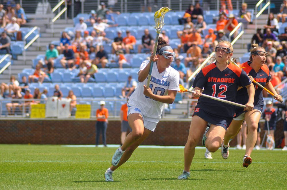 <p>UNC junior midfielder Alyssa Long (10) carries the ball down the field during the women’s lacrosse game against Syracuse at Dorrance Field on Saturday, April 15, 2023. Syracuse defeated UNC 14-12.</p>