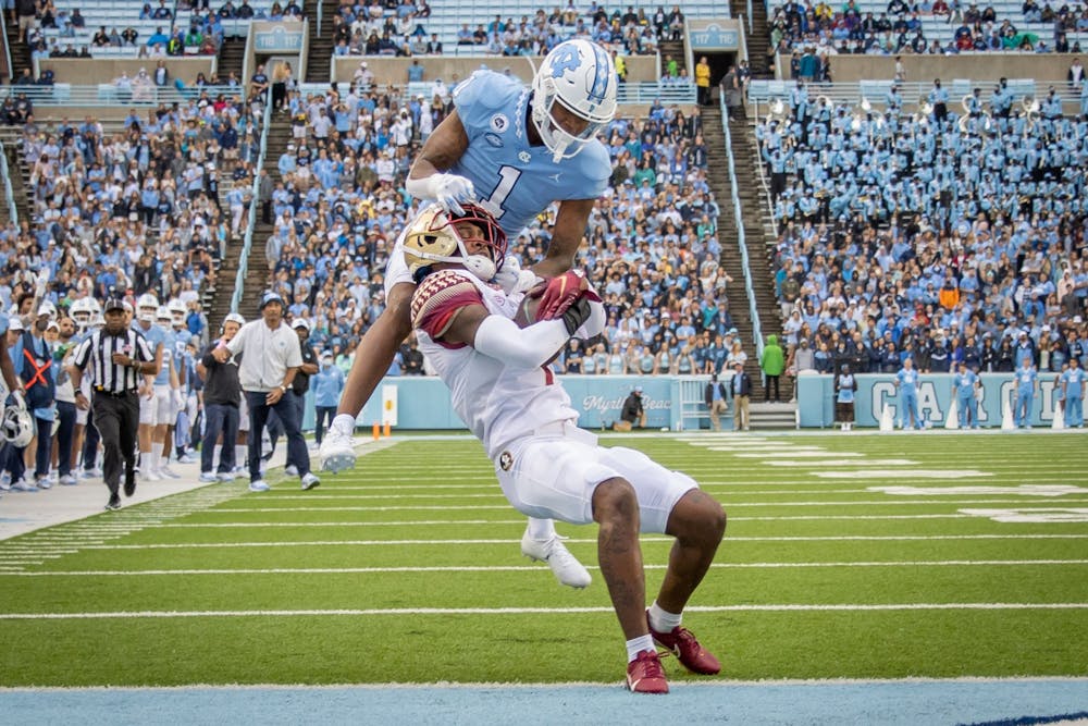 <p>FSU sophomore defensive back Jarrian Jones (7) intercepts a long pass intended for UNC sophomore wide receiver Khafre Brown (1) during the Tar Heels' home football matchup in Kenan Memorial Stadium on Oct. 9, 2021, against the Florida State Seminoles. FSU won 35-25.&nbsp;</p>