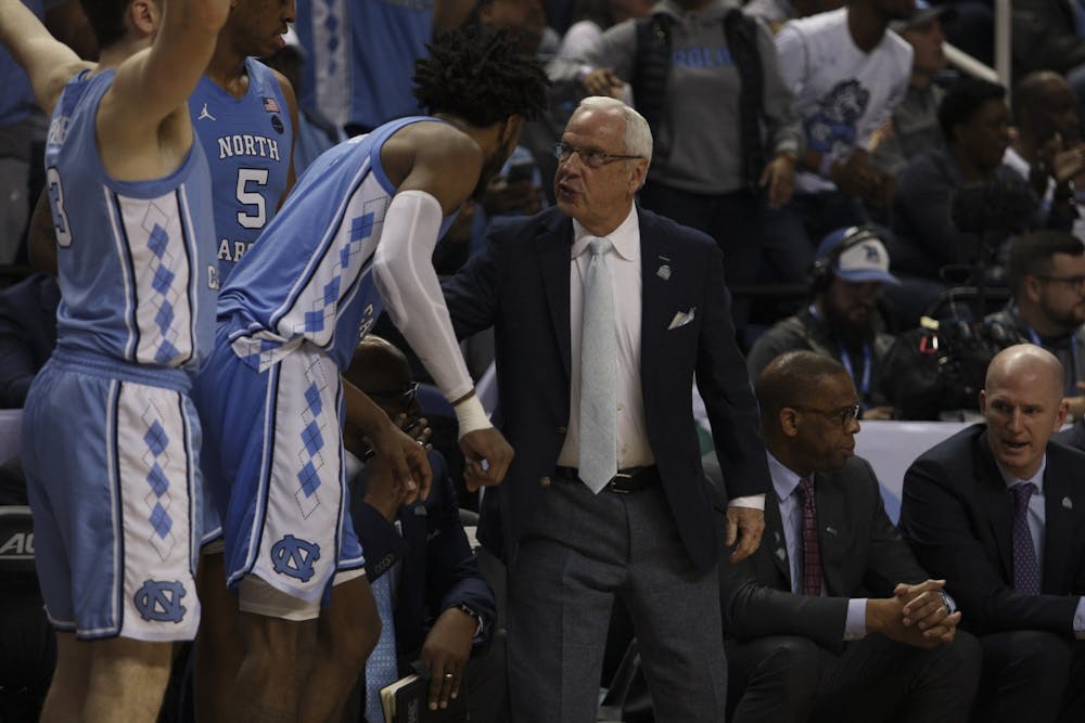 <p>Head Coach Roy Williams speaks to then-sophomore &nbsp;guard Leaky Black (1) during the first round game of the ACC tournament against Virginia Tech in the Greensboro Coliseum Complex on Tuesday, March 10, 2020. UNC beat Virginia Tech 78-56.</p>