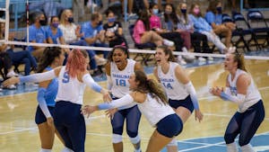 UNC women's volleyball players celebrate after scoring a point at the game against Duke on Oct. 22 at Carmicahel Arena. UNC won 3-0.