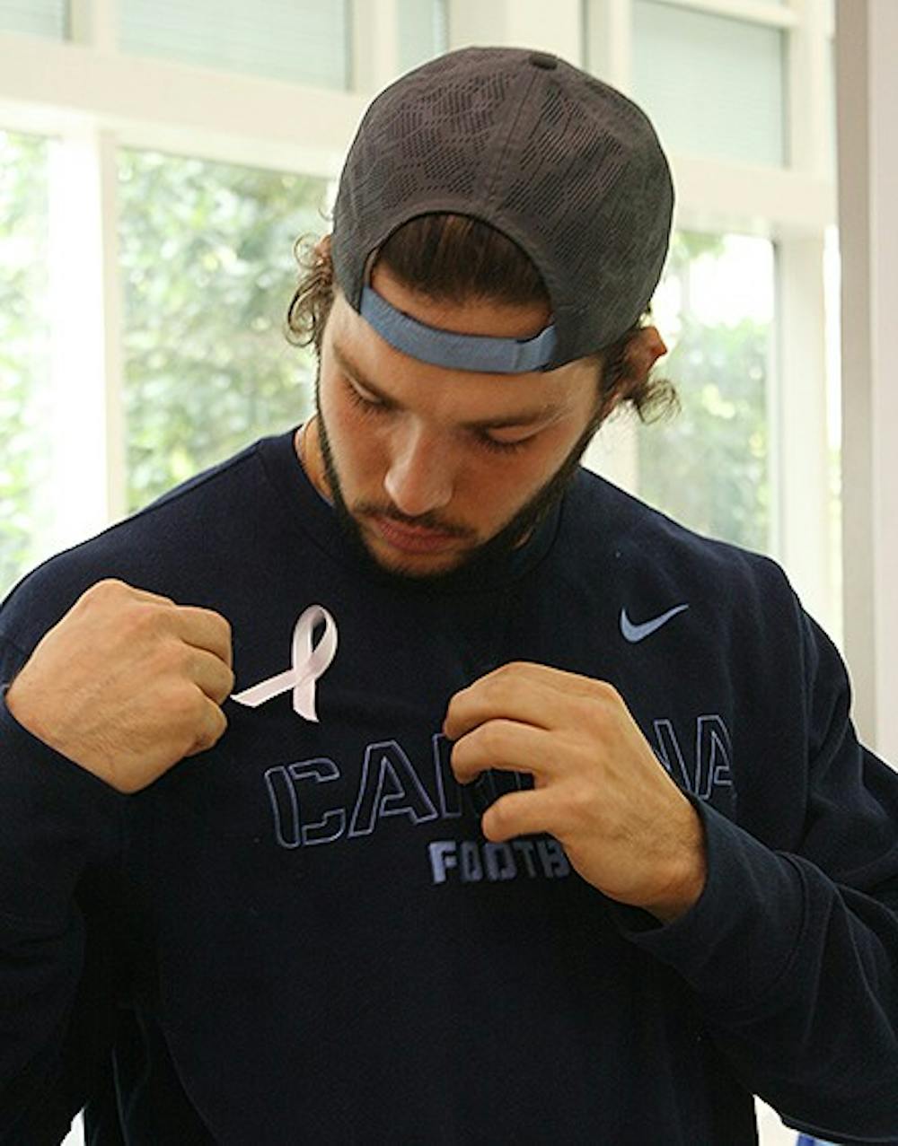 Nick Weiler, a sophomore on the football team, shows his support for Domestic Violence Awareness month by participating in the 7th annual "Carolina Men Care" event. This is when UNC athletes pair up with BEACON Child and Family Program at the UNC Children's Hospital to spread awareness about domestic violence and sexual assault. 