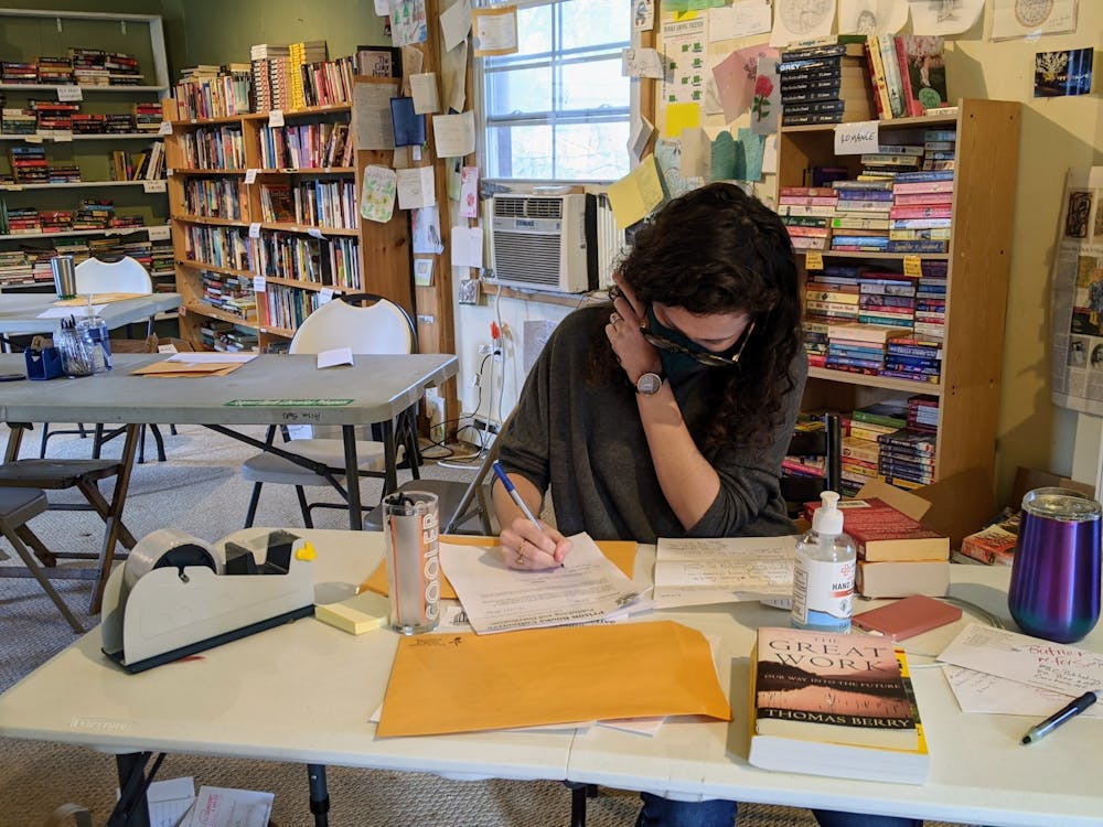 <p>A volunteer answers a book request from an incarcerated individual. Photo courtesy of Liz Schlemmer.</p>