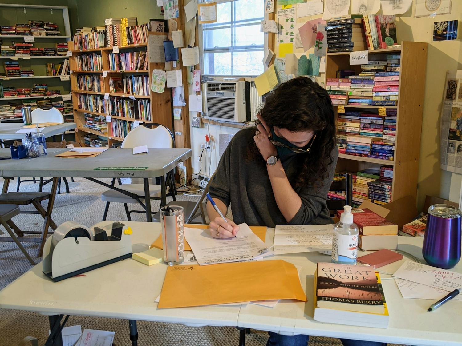 A volunteer answers a book request from an incarcerated individual. Photo courtesy of Liz Schlemmer.